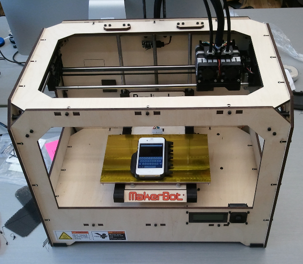 Photograph of the MakerBot with the iPhone Adapted Case sitting on the printing plate (for size comparison).